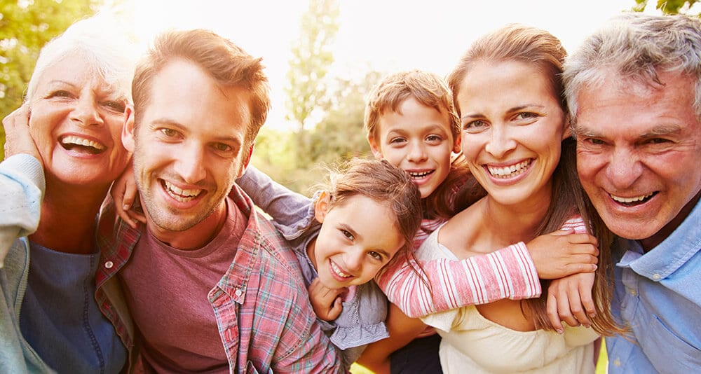A smiling multi-generational family — Focus Care covers individuals and whole families