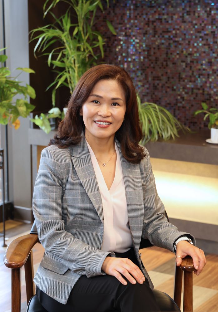 Dr. Misook An Rissler, DDS, seated in the lobby of Focus Dental Studio